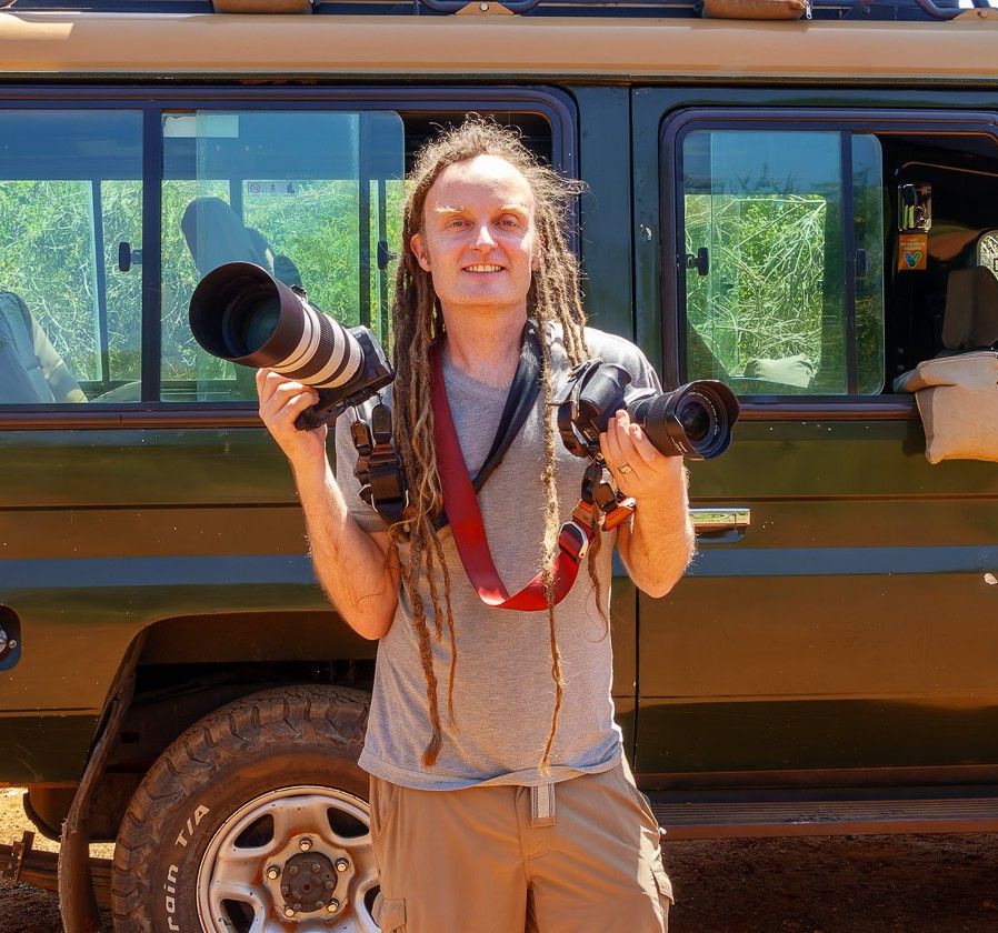 Laurence Norah with two cameras and telephoto lenses, on safari in Africa